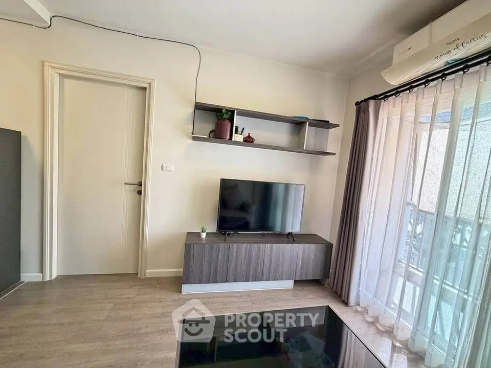 Modern living room with sleek TV stand and balcony view