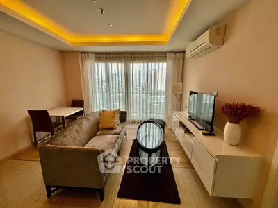 Modern living room with elegant furniture and city view, featuring ambient lighting and sleek design.