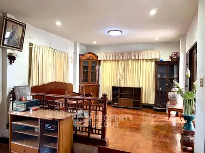 Spacious living room with wooden flooring and elegant furnishings in a cozy home setting.