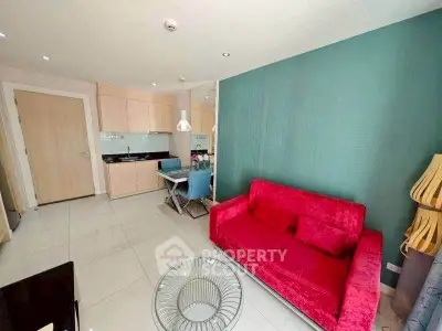 Modern living room with vibrant red sofa and stylish dining area