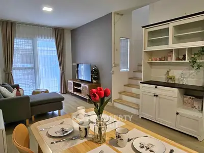 Charming living room with modern decor and cozy dining area, perfect for relaxation and entertaining.