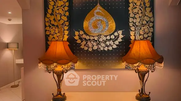 Elegant interior with decorative lamps and ornate wall art in a cozy setting.