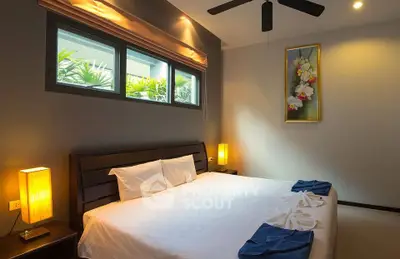 Serene and inviting bedroom with a large comfortable bed, warm lighting, and a tranquil view through the window, perfect for restful nights.