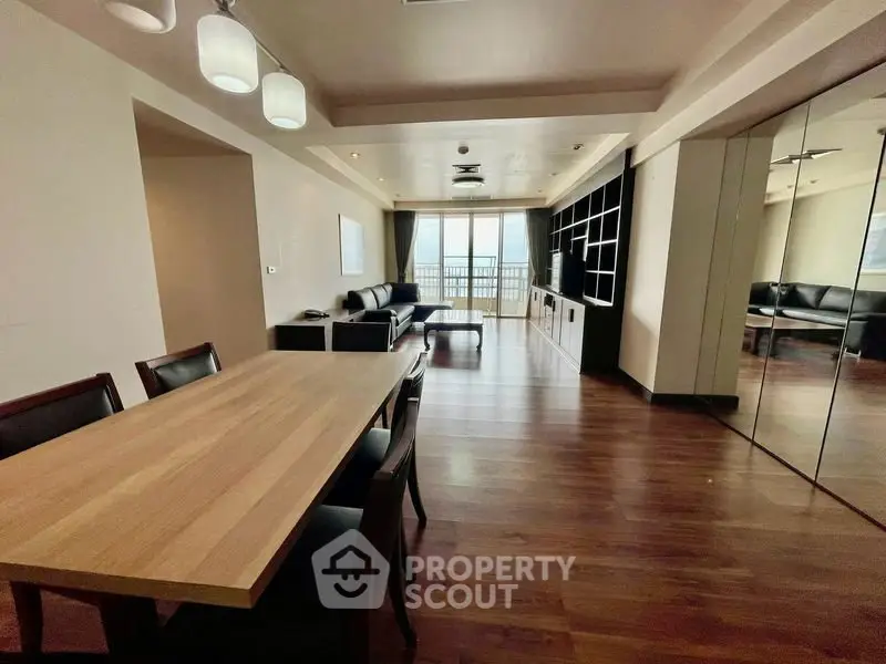 Spacious modern living room with wooden flooring and elegant dining area