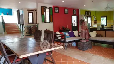 Spacious living room with vibrant decor and wooden furniture