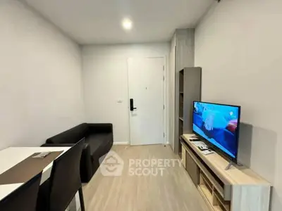 Modern living room with sleek furniture and flat-screen TV, perfect for cozy relaxation.