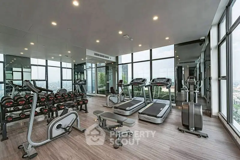 Modern high-rise gym with panoramic city views and state-of-the-art equipment.