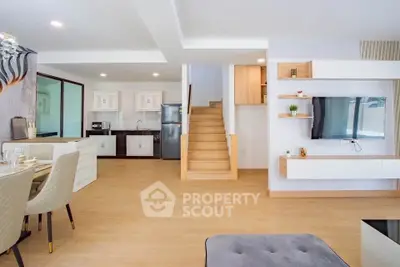 Modern open-plan living room with kitchen and stylish decor