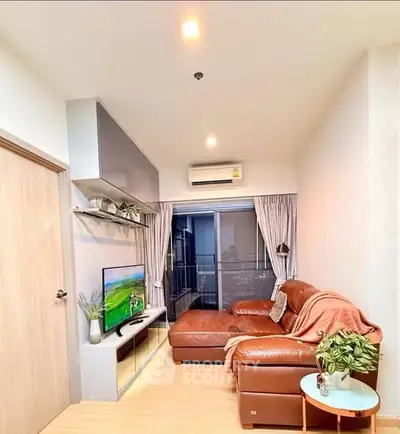Cozy living room with leather sofa and modern decor in a high-rise apartment.
