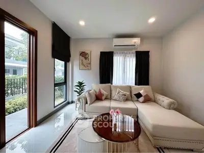 Stylish living room with modern sofa, air conditioning, and large window view.