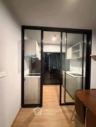 Modern kitchen with sleek sliding glass doors and contemporary cabinetry