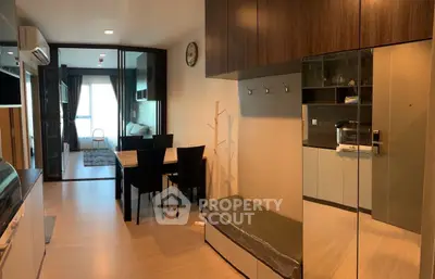 Modern open-plan living and dining area with sleek furniture and natural light.