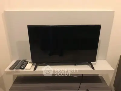 Modern living room with sleek TV setup on stylish white stand