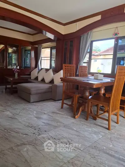 Spacious living room with elegant wooden furniture and marble flooring