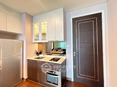 Modern kitchen with sleek cabinetry and built-in appliances in a stylish apartment.