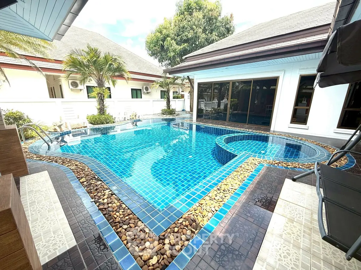 Stunning private pool with modern design in luxurious villa setting