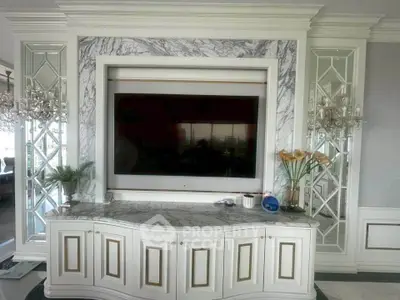 Luxurious living room with elegant marble TV wall and mirrored accents