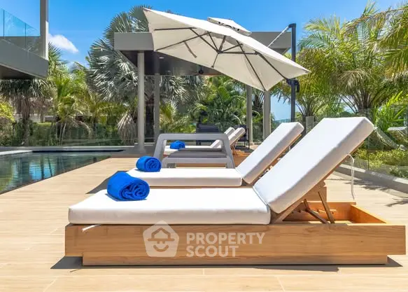 Luxurious poolside with sun loungers and umbrella in tropical setting