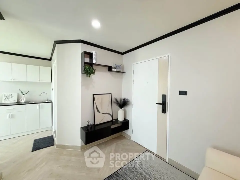 Modern apartment entrance with sleek kitchen and stylish decor