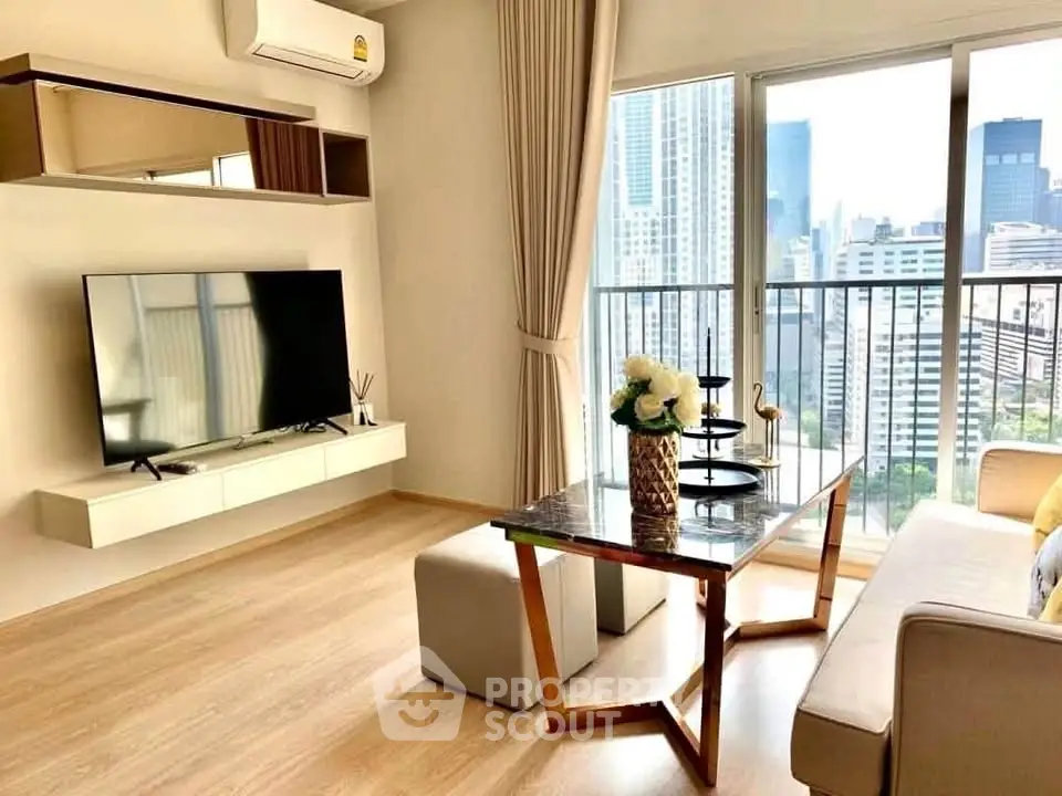 Modern living room with city view, featuring sleek furniture and large TV, perfect for urban living.