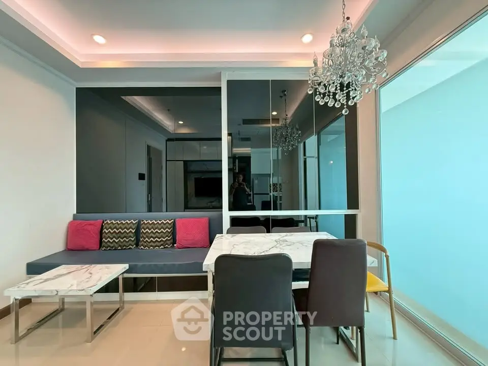 Modern living room with elegant chandelier and stylish furniture