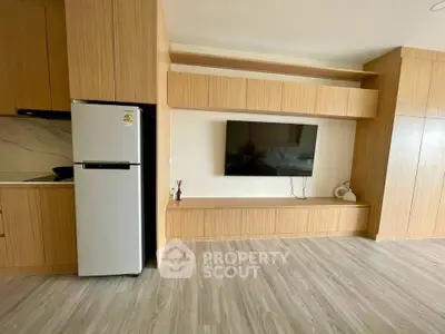 Modern living room with wooden cabinetry and sleek TV setup