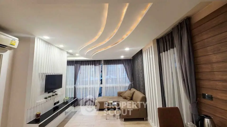 Modern living room with stylish ceiling lights and cozy sectional sofa