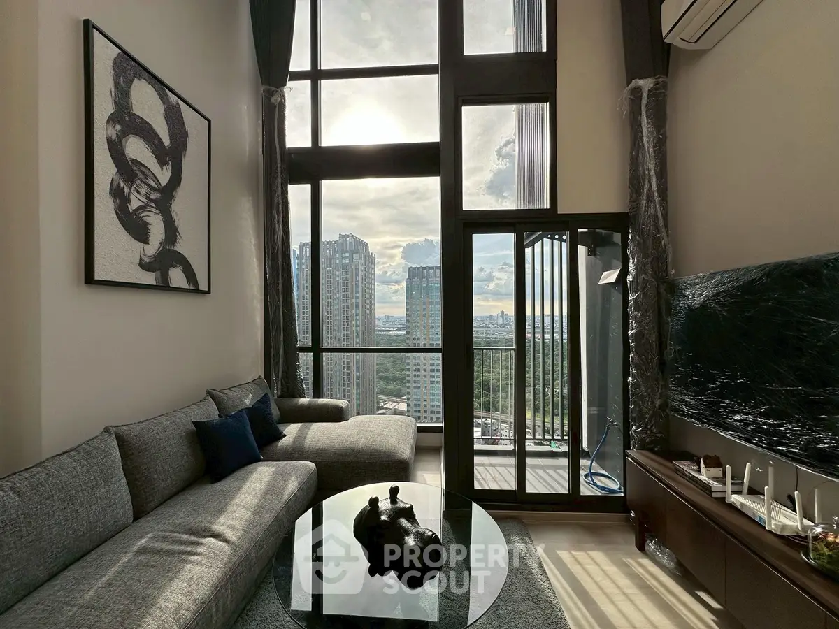 Luxurious high-rise living room with floor-to-ceiling windows and stunning city view.