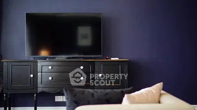 Stylish living room with modern TV setup and elegant furniture.