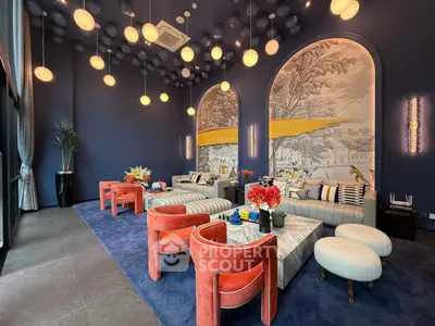 Luxurious living room with elegant decor, featuring plush seating and artistic wall design in a modern apartment.