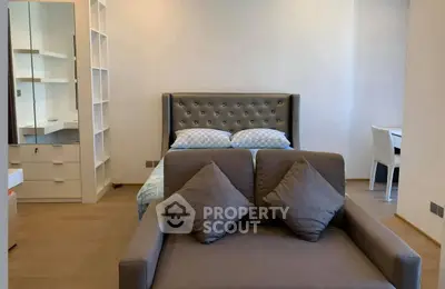 Modern bedroom with stylish decor and cozy seating area