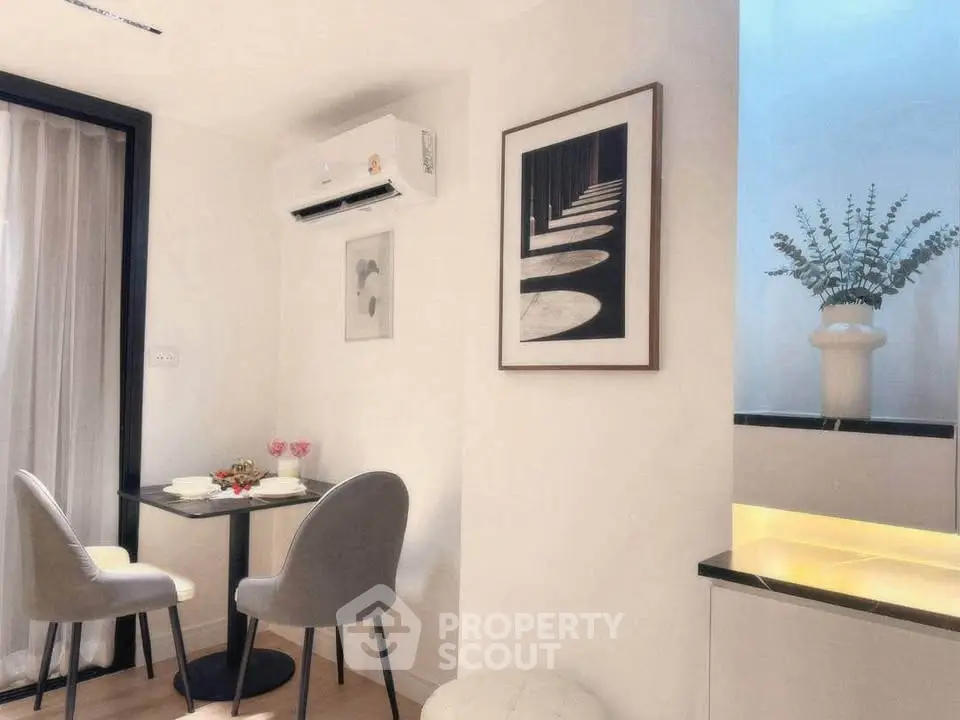 Chic dining nook with modern decor and air conditioning in a stylish apartment.