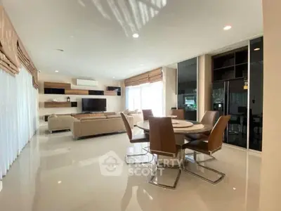 Spacious modern living room with elegant dining area and sleek furniture