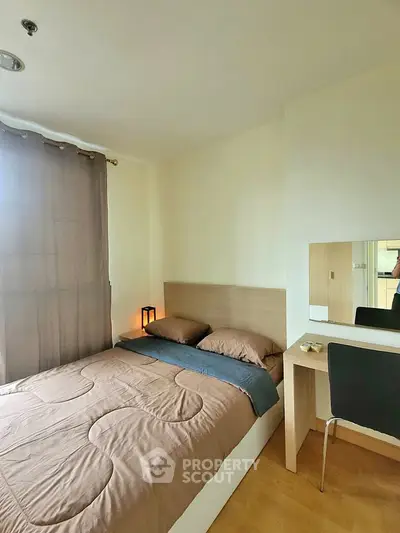 Cozy bedroom with modern decor and natural light, perfect for relaxation and comfort.