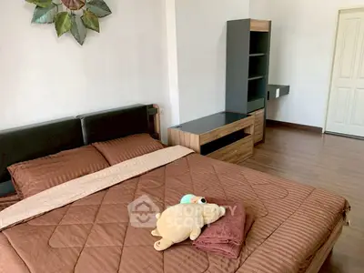 Cozy bedroom with modern furniture and plush bedding in a stylish apartment.