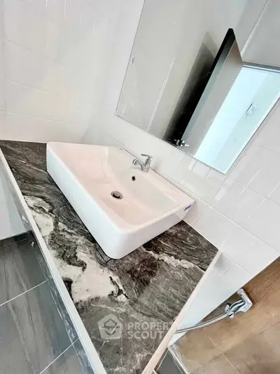 Modern bathroom with sleek sink and marble countertop