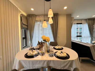 Elegant dining area with modern lighting and stylish table setting in a cozy apartment.