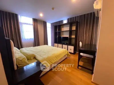 Spacious bedroom with modern furnishings and natural light