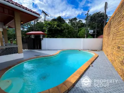 Charming backyard with a private pool and lush greenery, perfect for relaxation and entertainment.