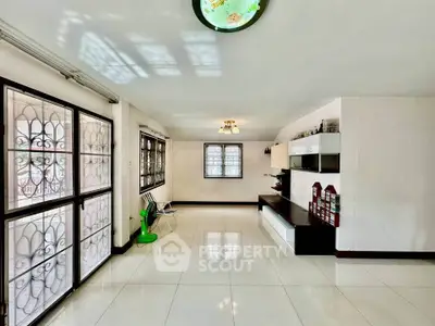 Spacious living room with modern decor and large windows for natural light.