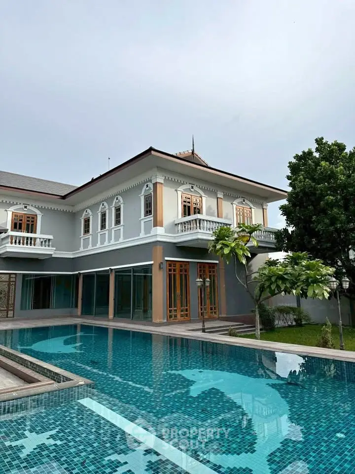 Luxurious villa with elegant architecture and private pool, surrounded by lush greenery, perfect for upscale living.