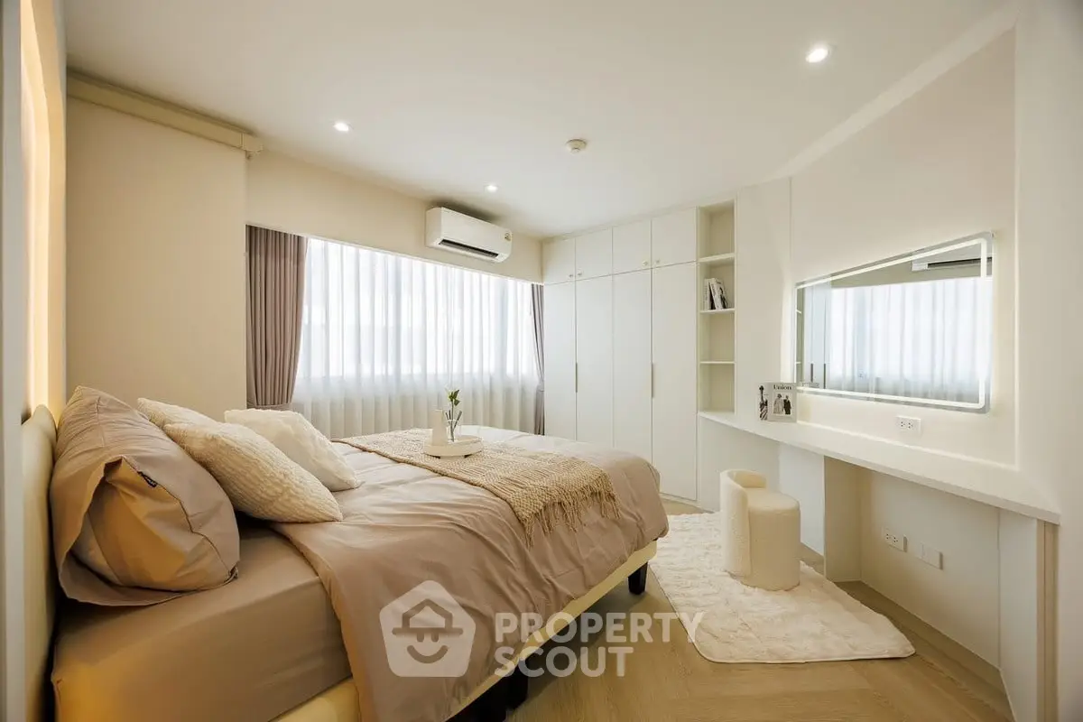 Luxurious bedroom with elegant decor and ample natural light