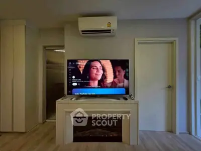 Modern living room with TV and air conditioning, featuring sleek built-in cabinetry and elegant flooring.