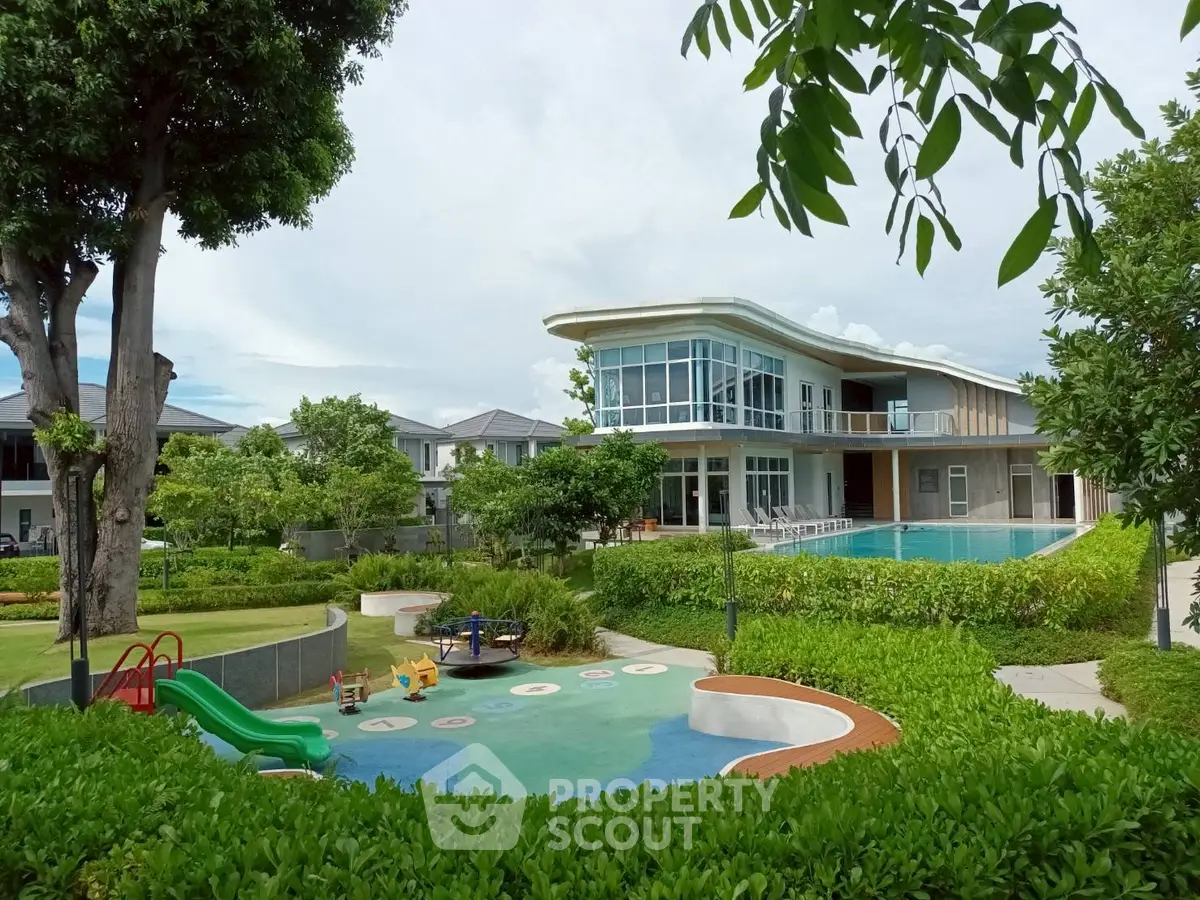 Luxurious modern house with pool and playground in lush garden setting