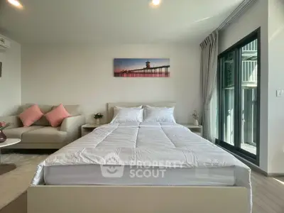 Modern bedroom with cozy decor and large window for natural light