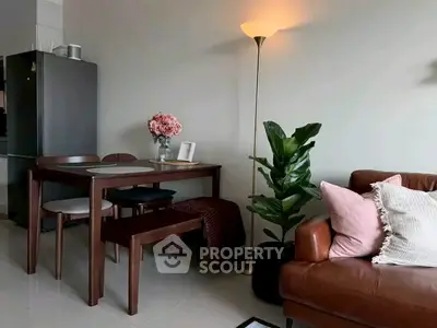 Chic living room with modern dining set, leather sofa, and stylish decor in cozy apartment.