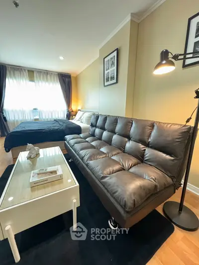 Modern studio apartment with cozy leather sofa and stylish decor