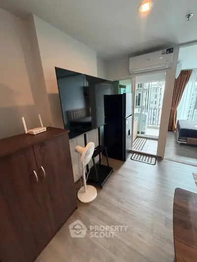 Modern living room with sleek furniture and balcony access in a stylish apartment.