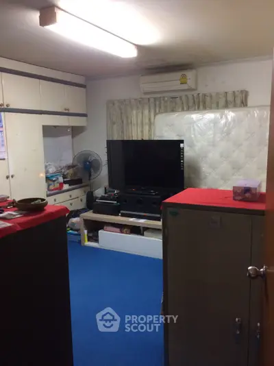 Cozy living room with blue carpet and entertainment center