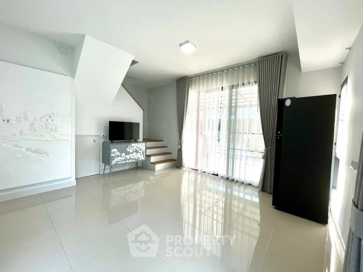 Spacious modern living room with sleek design and large windows for natural light.